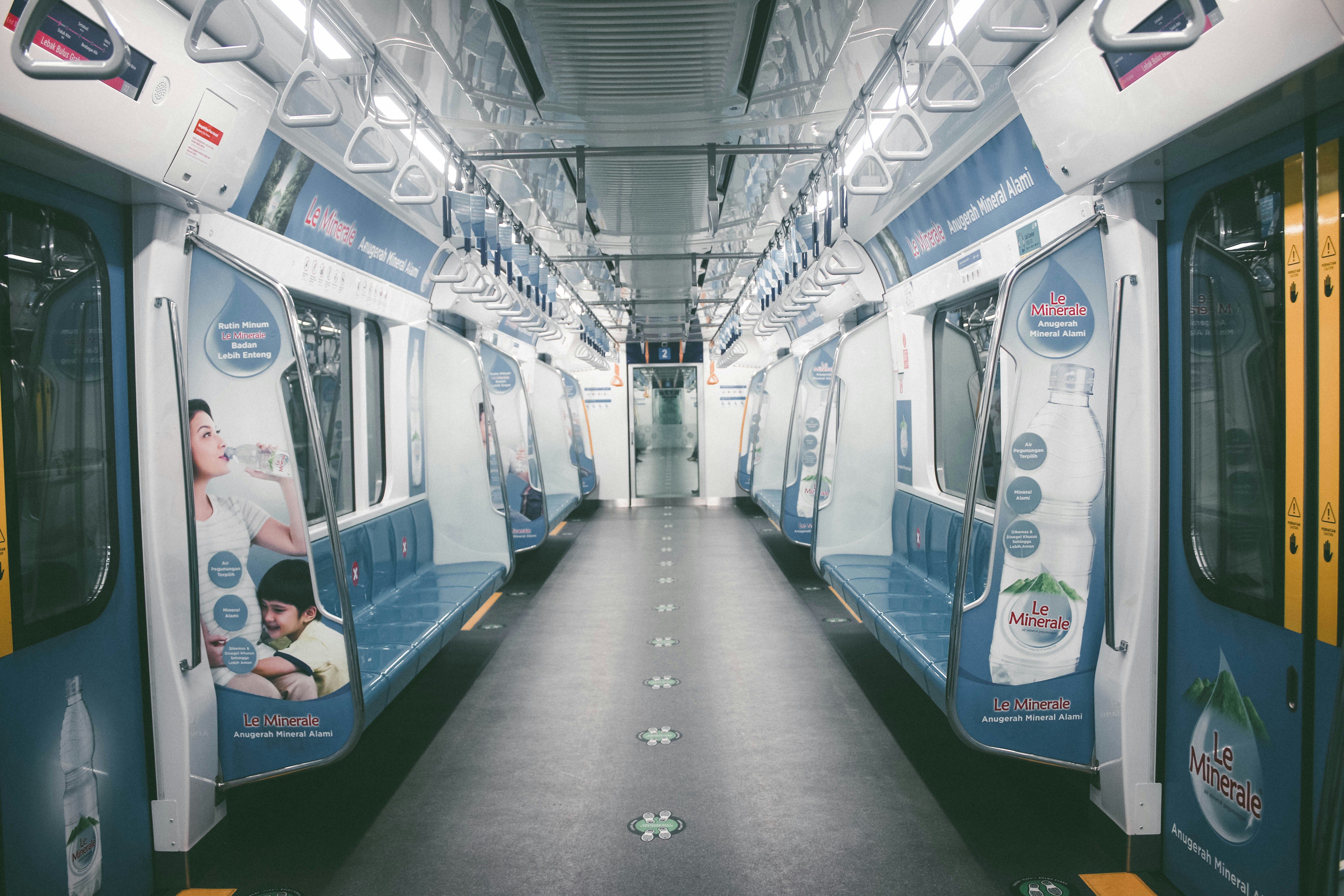 a subway car with advertisements on the side of it, 