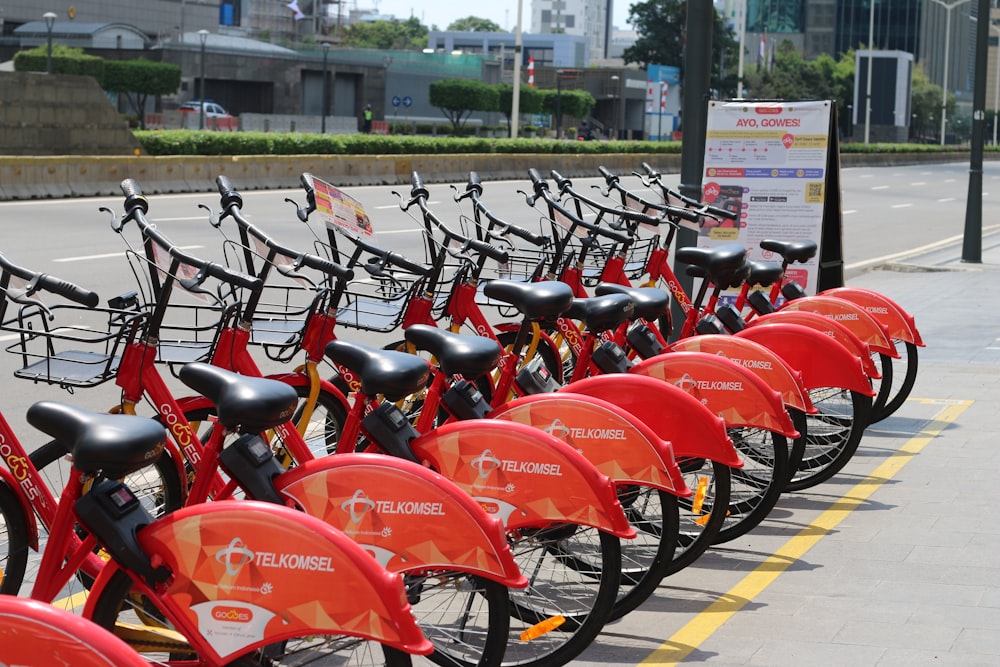 a row of red bikes parked next to each other