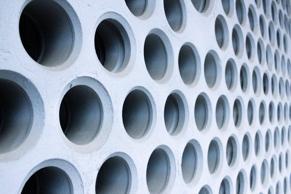 a close up of a wall made of cement circles