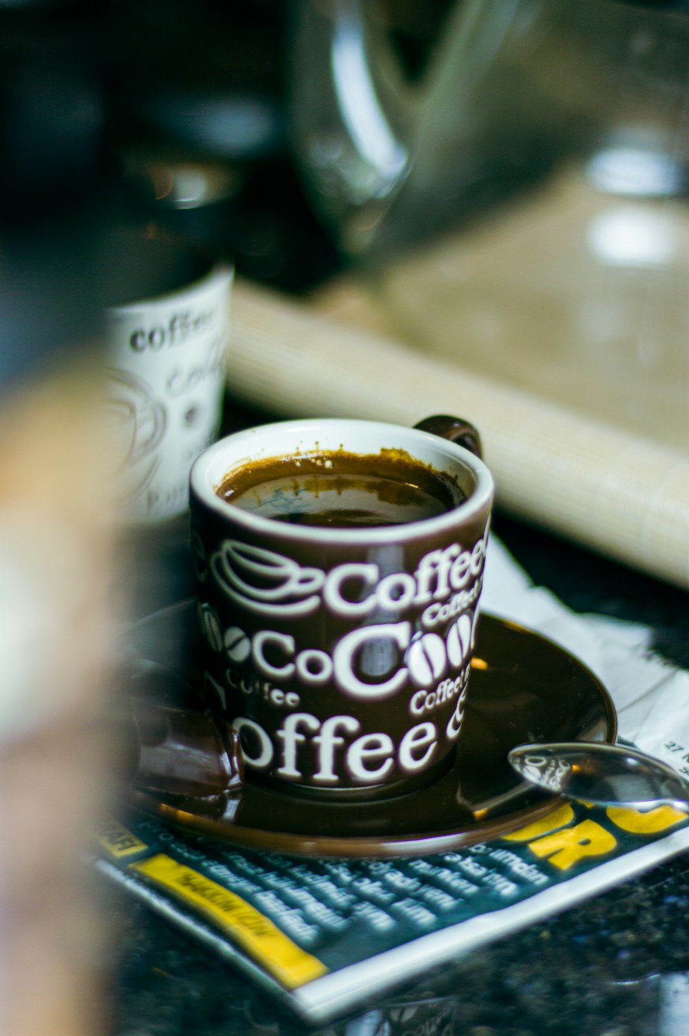 a cup of coffee sitting on top of a table