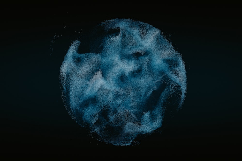 a blue substance is in the middle of a black background