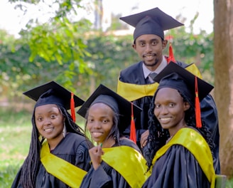 a group of people in graduation gowns posing for a picture