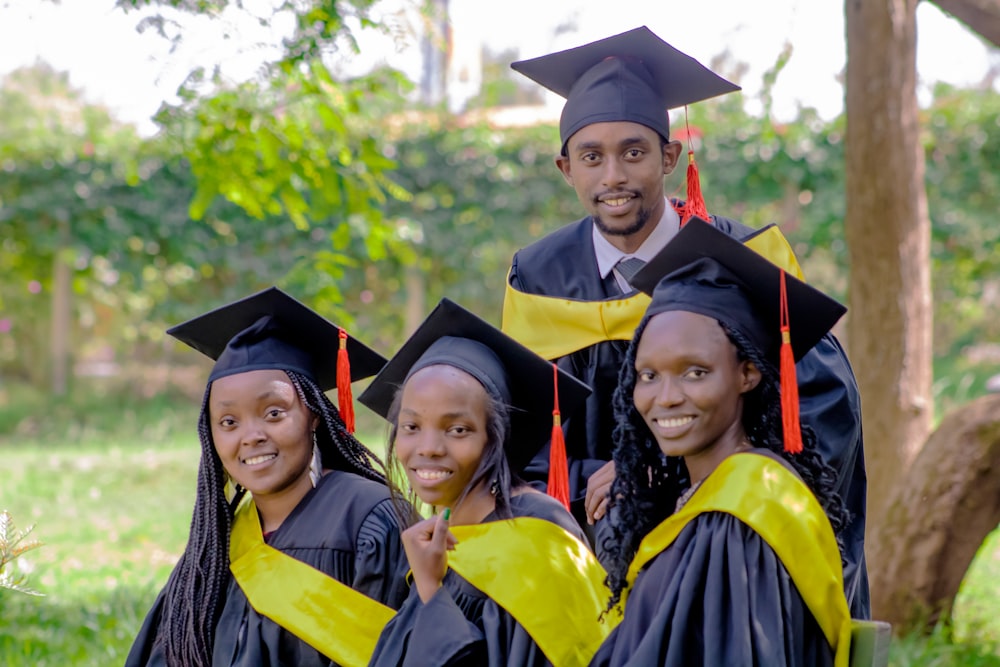 a group of people in graduation gowns posing for a picture