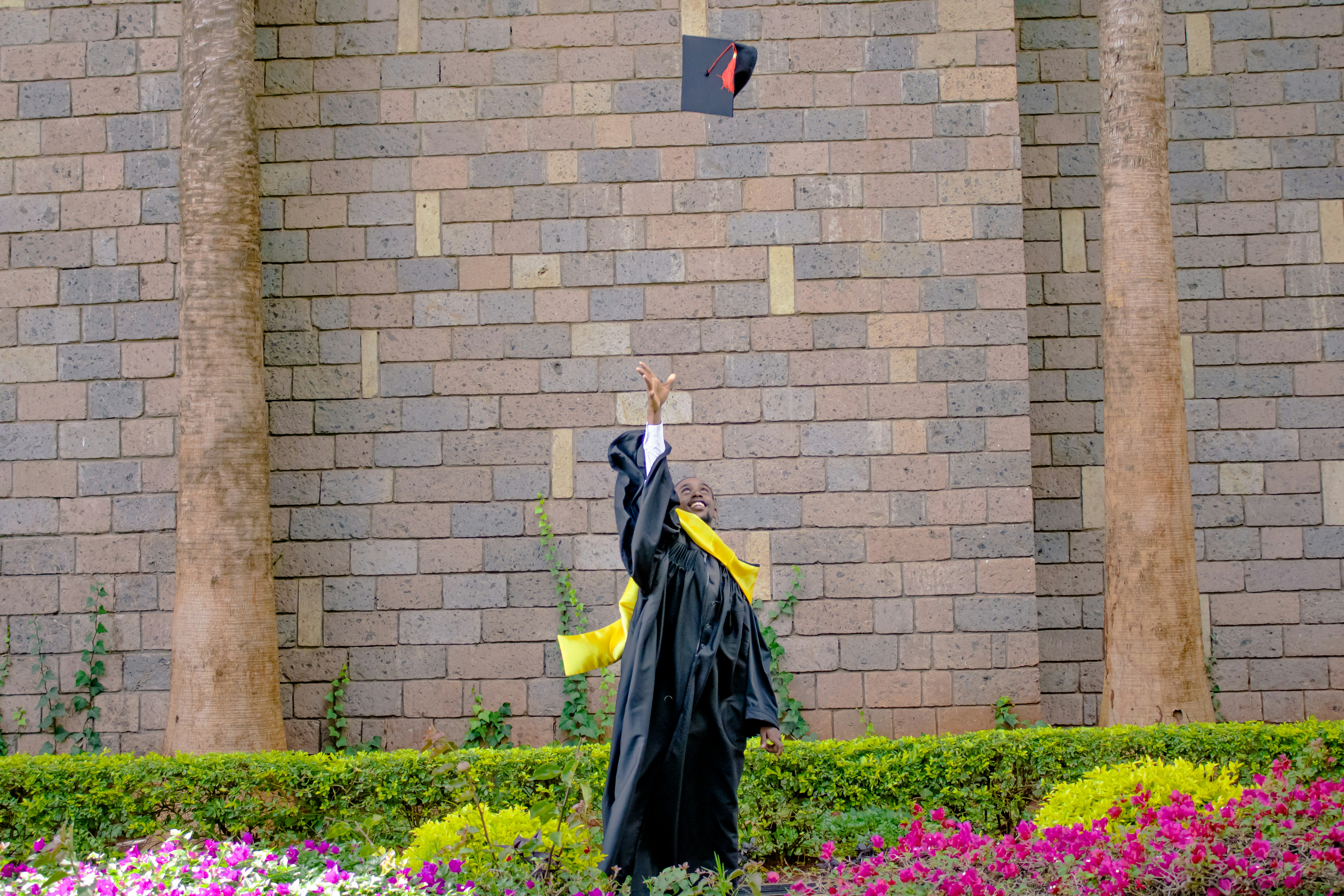 a graduate throwing a mortar in the air