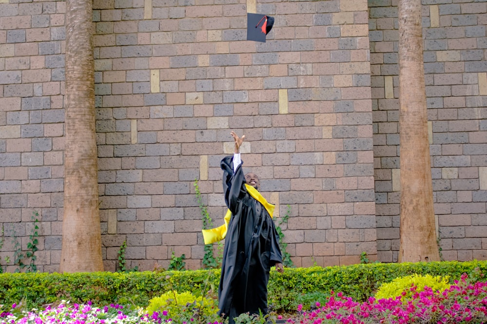a graduate throwing a mortar in the air
