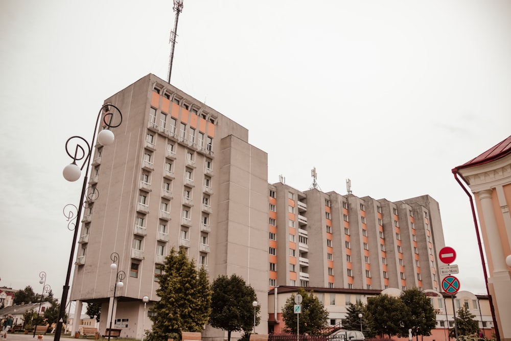 a large building with many windows next to a street