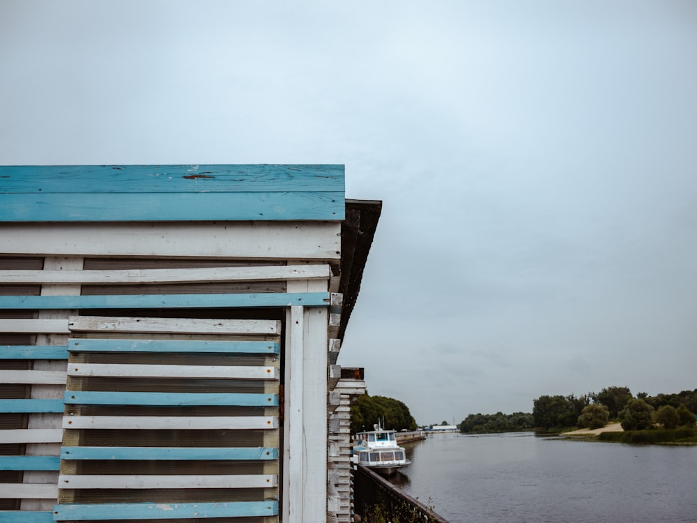 a blue and white building next to a body of water