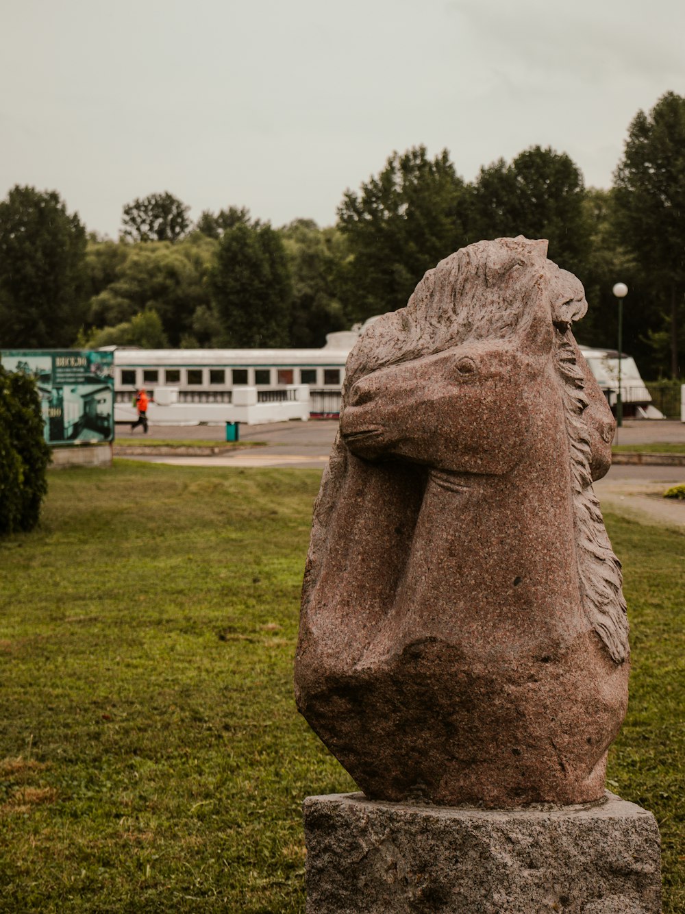 a statue of a horse in a grassy area