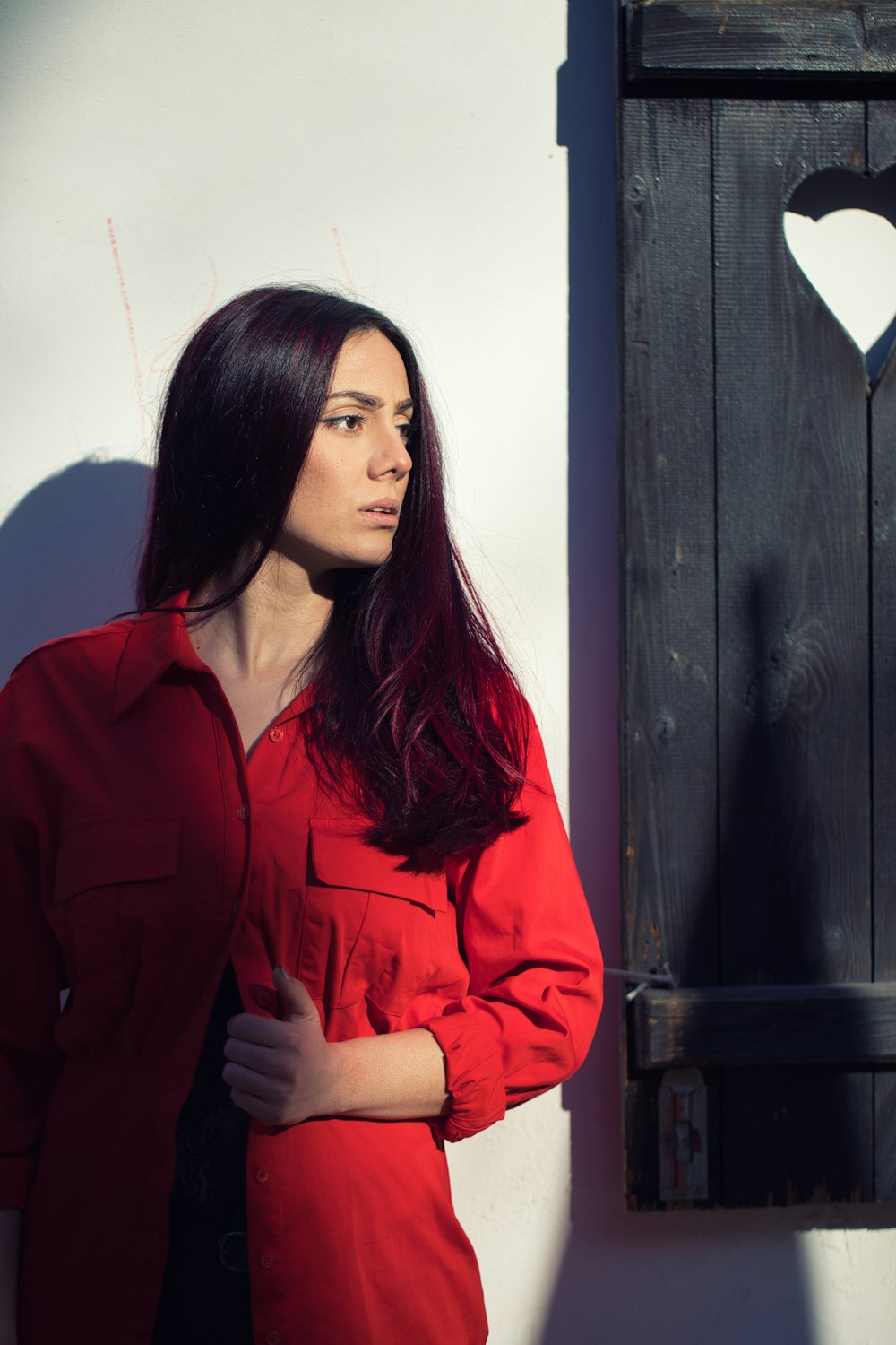 a woman standing in front of a wooden door