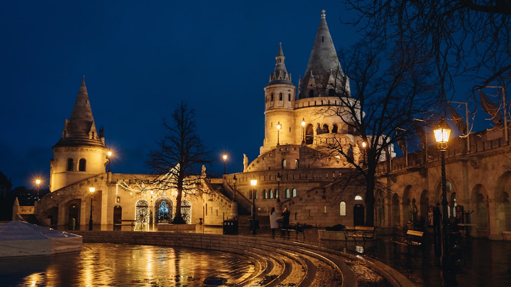 a large building with a clock tower at night