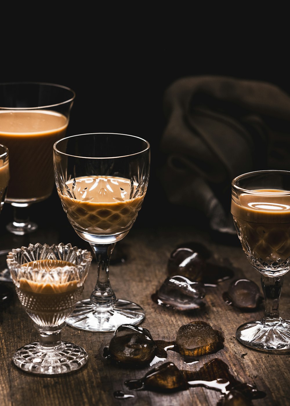 a table topped with glasses filled with liquid