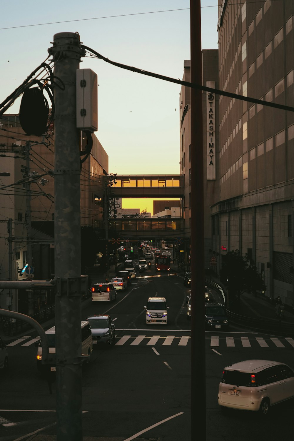 a city street filled with lots of traffic next to tall buildings