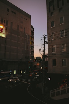 Technicians installing fiber optic cables along a city street at dusk.