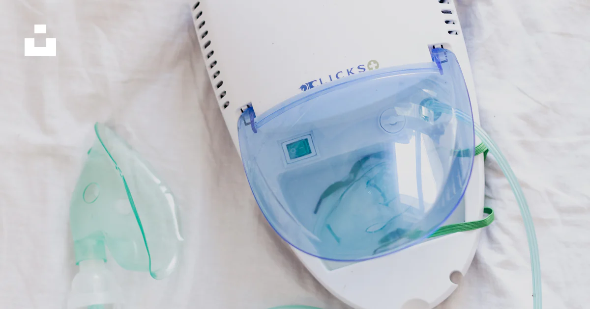 A ventilator and oxygen inhaler on a bed photo – Free Asthma Image on ...