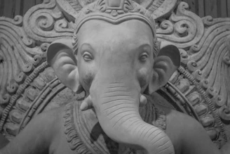 Close-up of the intricate textures and sacred crimson highlights on a Lord Hanuman figure