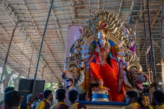 a large statue of a person sitting on top of a tiger