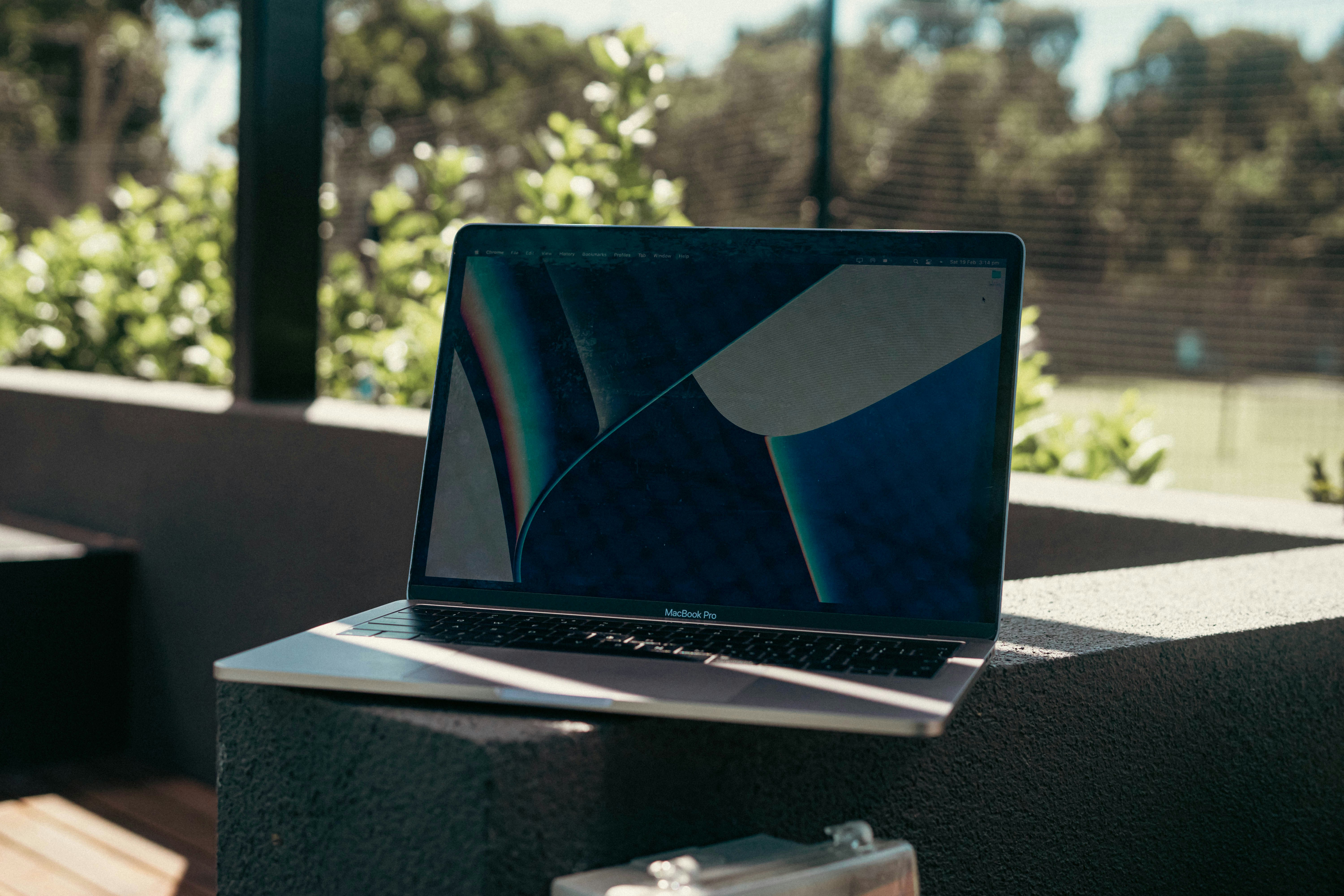 a laptop computer sitting on top of a wooden table