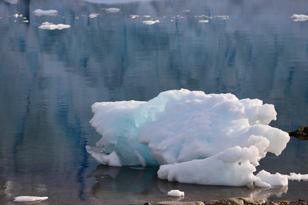 a large iceberg floating on top of a body of water