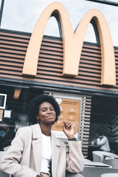 A confident business owner stands outside their Dave’s Hot Chicken franchise.