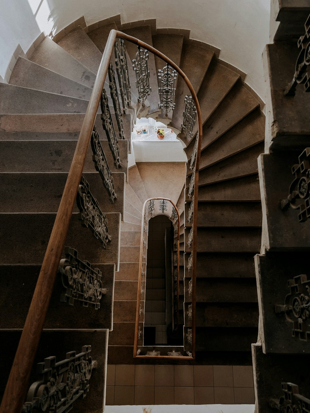 a spiral staircase in a building with a skylight