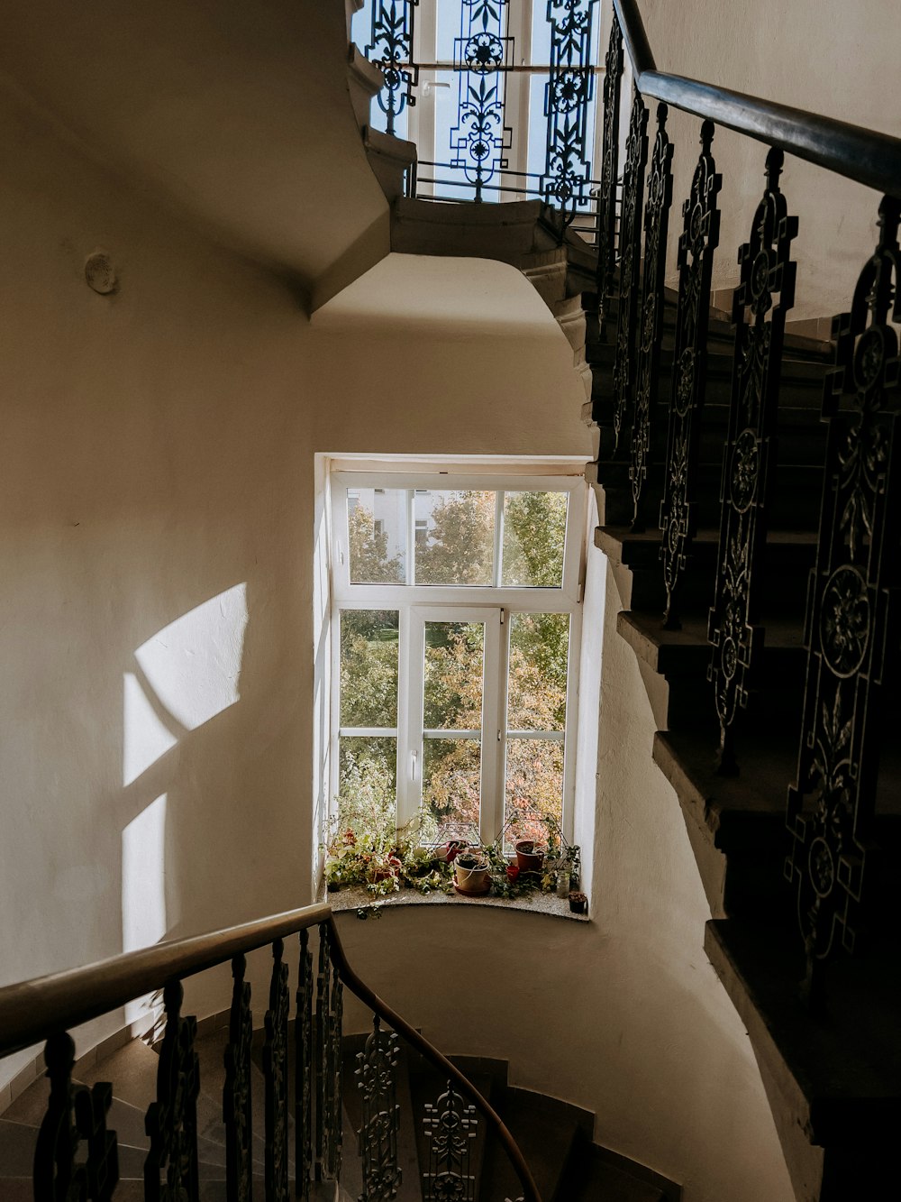 a staircase with a window and a railing