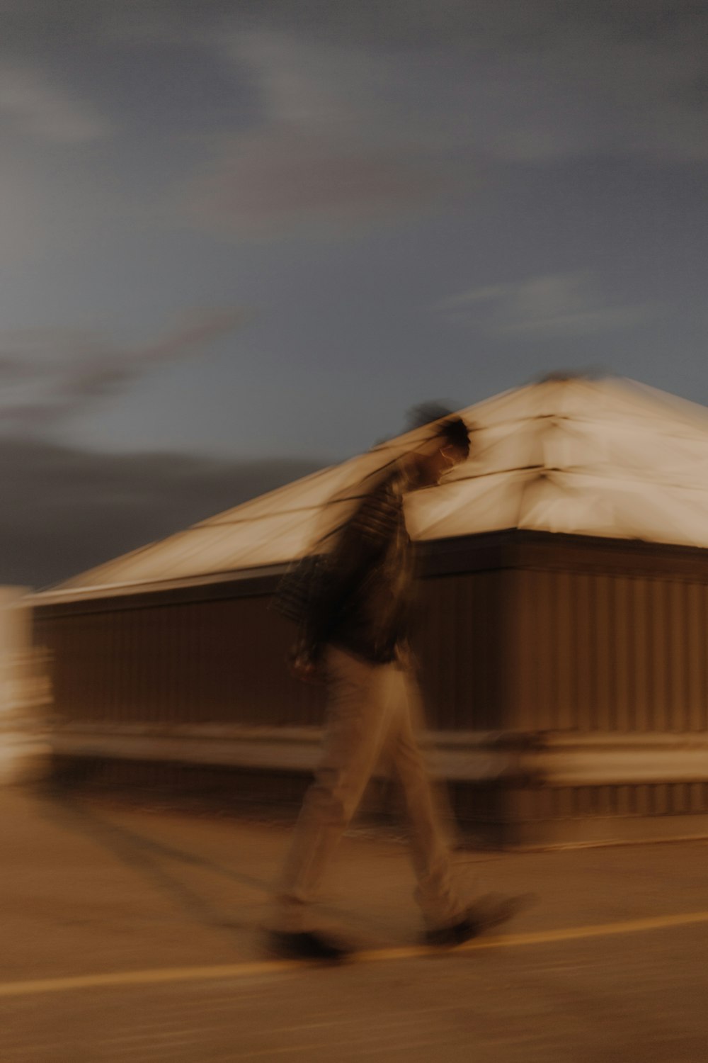 a blurry photo of a man walking down a street