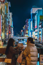 A vibrant evening scene of the Navigli district with glowing canal lights and lively crowds.