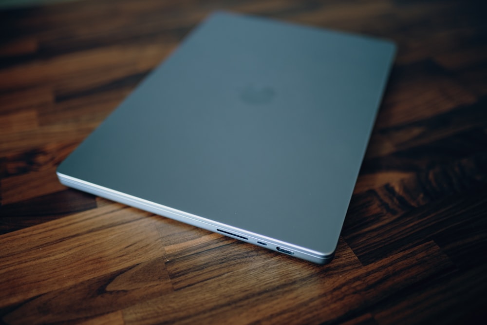 a close up of a laptop on a wooden table