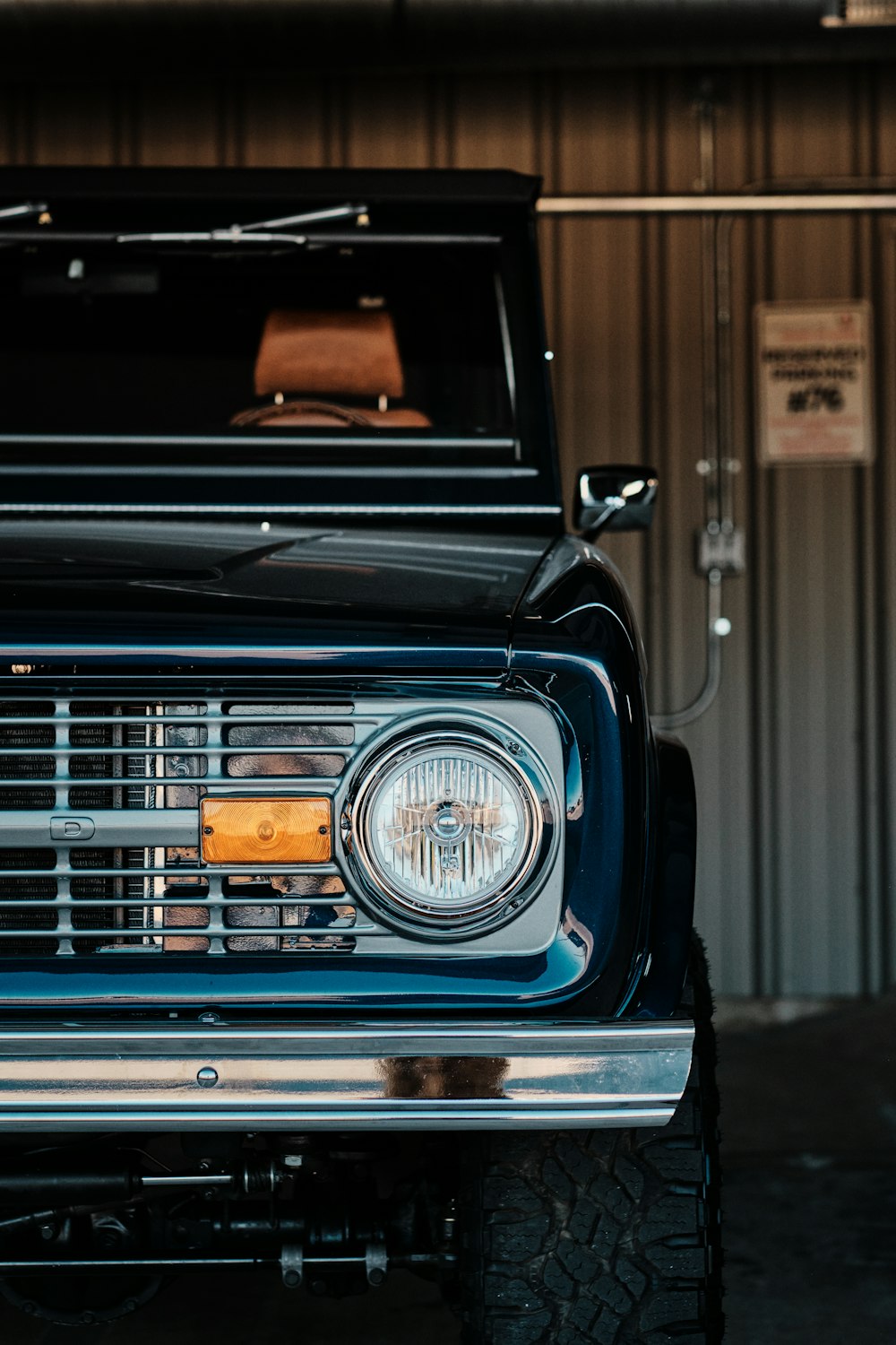 the front end of a black truck parked in a garage