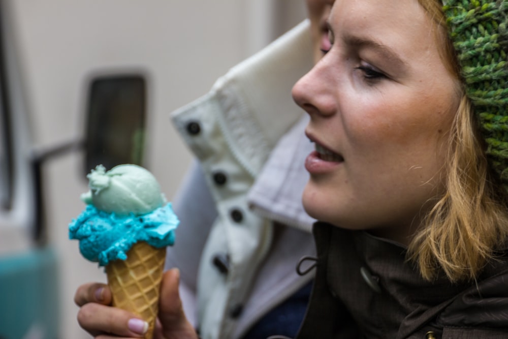 a woman is eating an ice cream cone