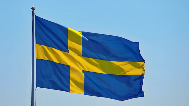 Swedish flag waving against a blue sky