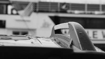Close-up of a car roof covered in small dents from a recent hailstorm.