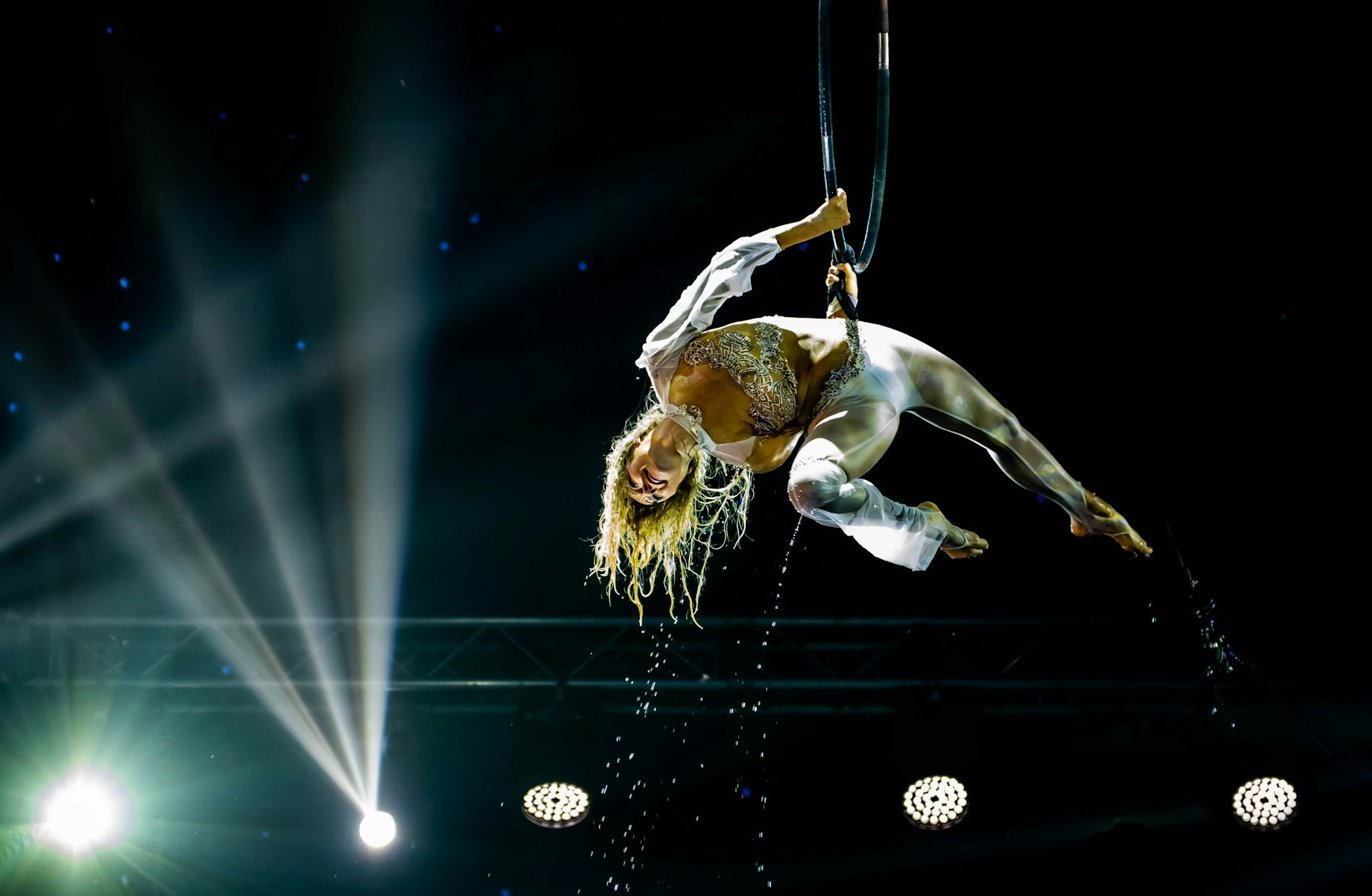 a woman is performing on a pole in the air