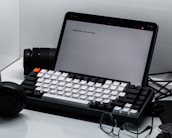 A clean, organized workspace featuring metal product samples and a laptop displaying product details.