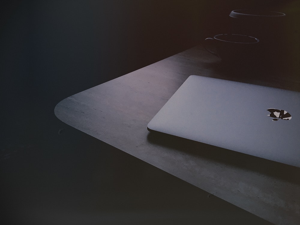 a laptop computer sitting on top of a wooden desk