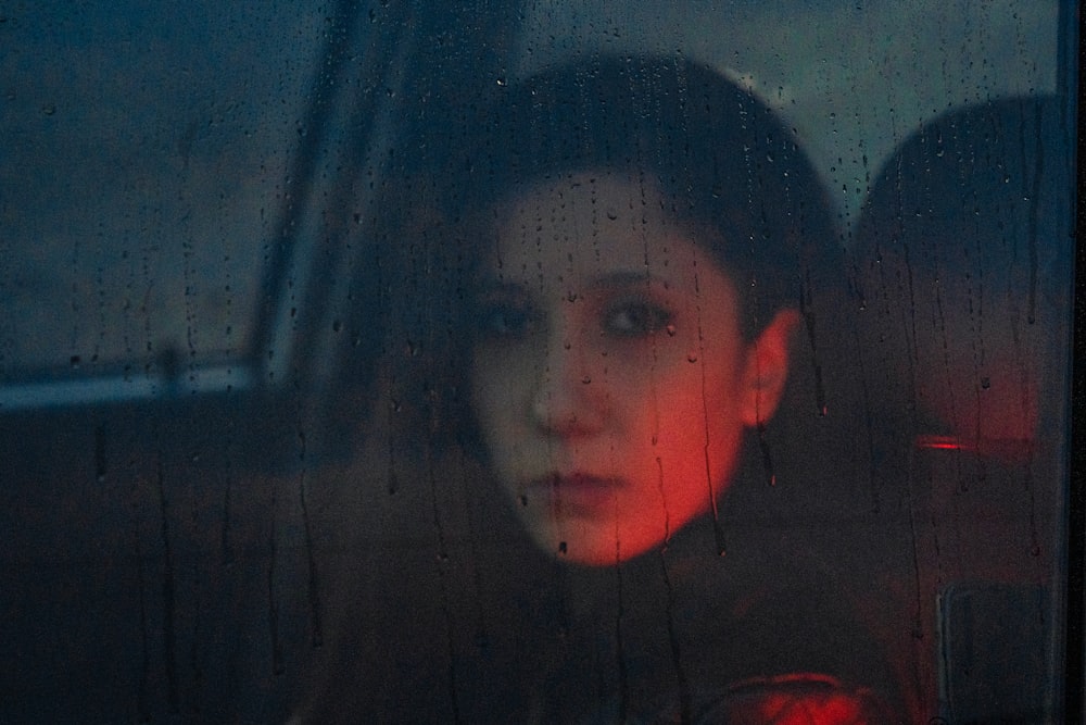 a woman sitting in the passenger seat of a car