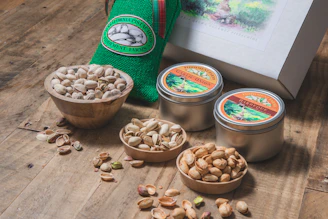 a box of nuts sits next to three bowls of nuts