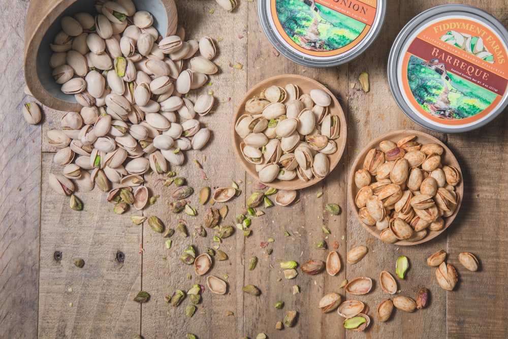 a wooden table topped with bowls of nuts