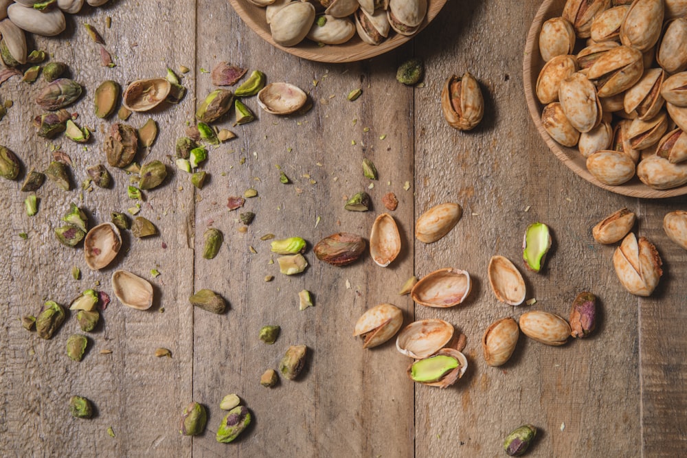 a wooden table topped with bowls filled with nuts