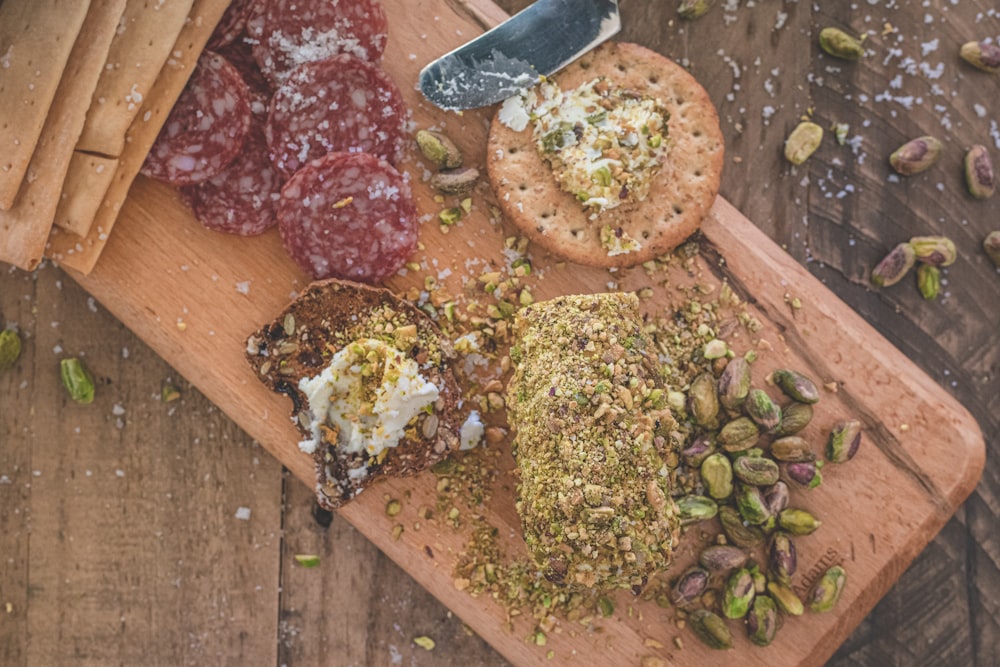 a wooden cutting board topped with different types of food