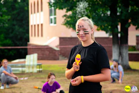 a girl with face paint holding a toy