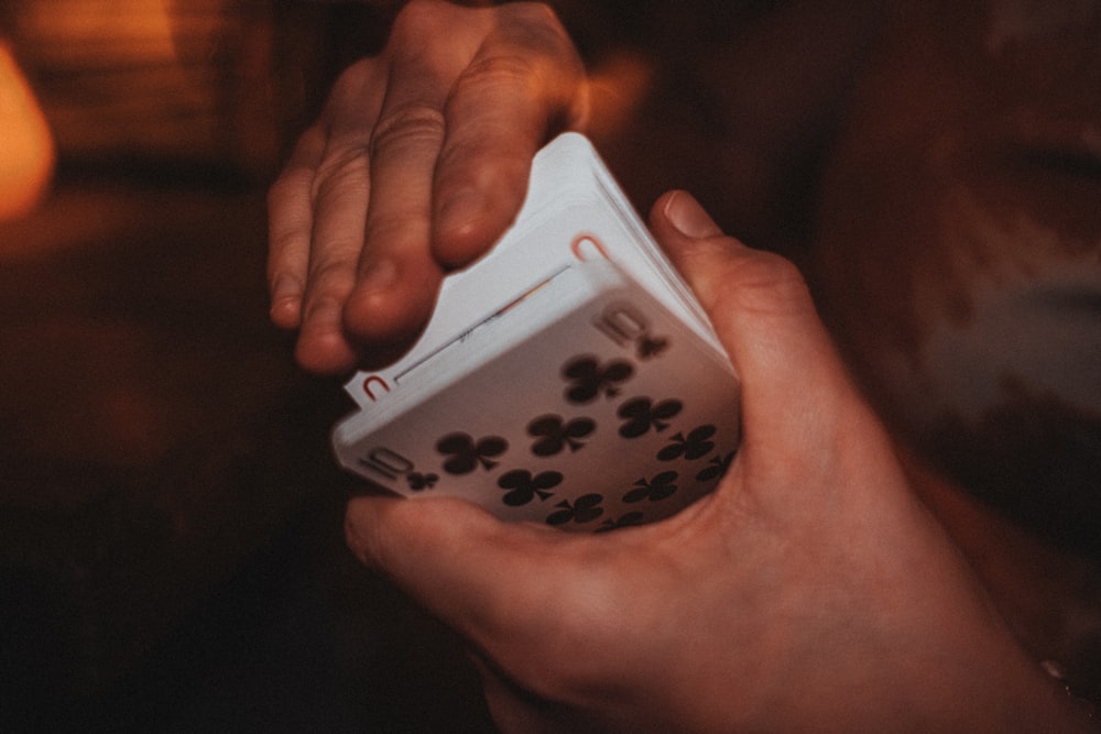 a person holding a dice in their hand
