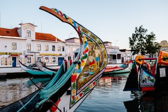 a row of colorful boats sitting on top of a body of water