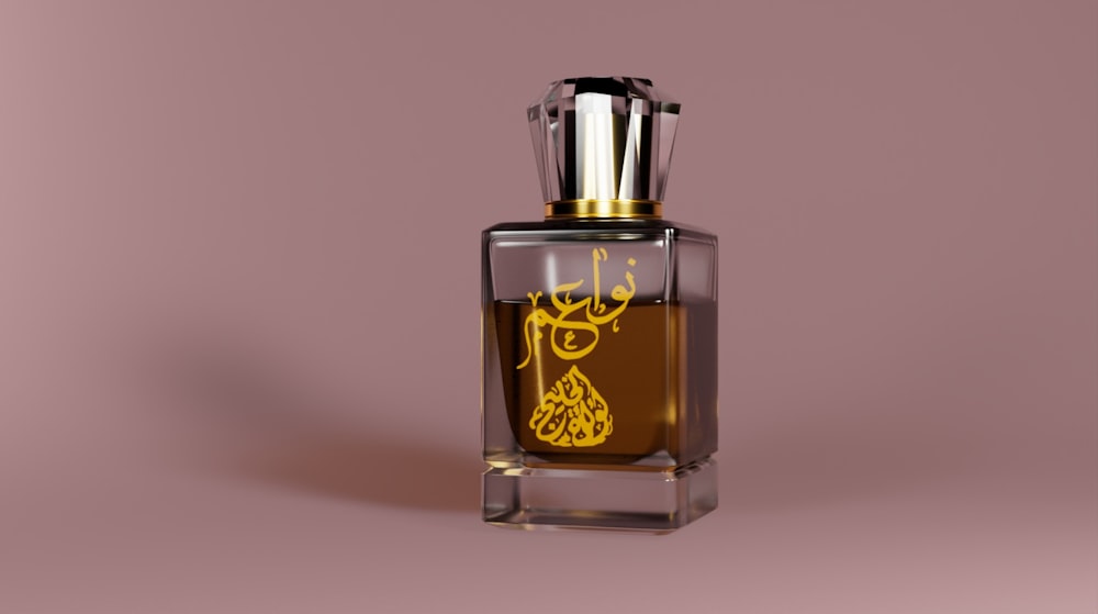 a bottle of perfume on a pink background