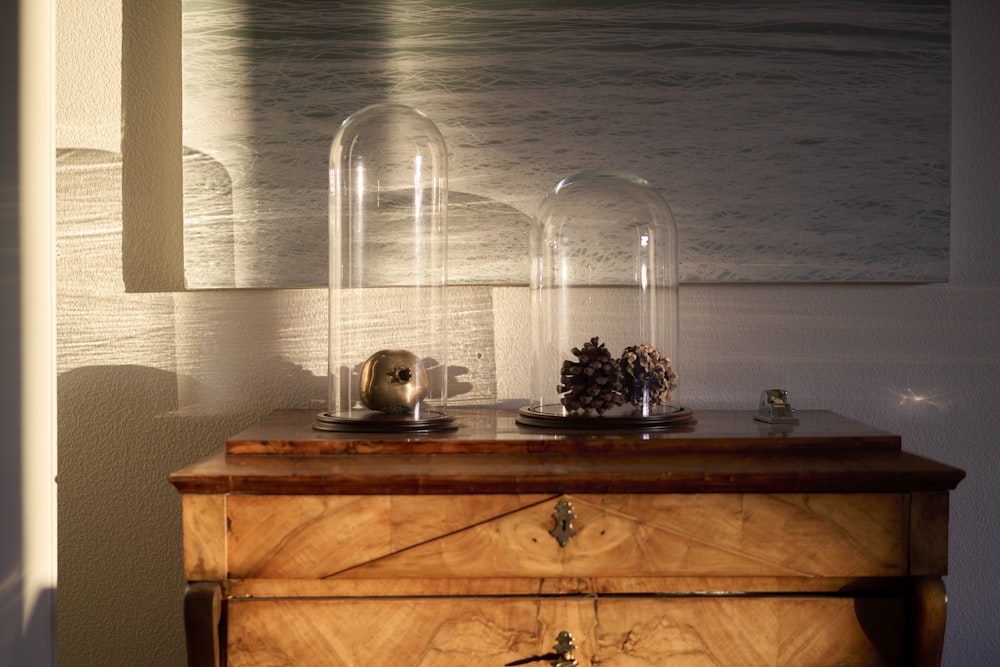 a wooden dresser with a glass dome on top of it