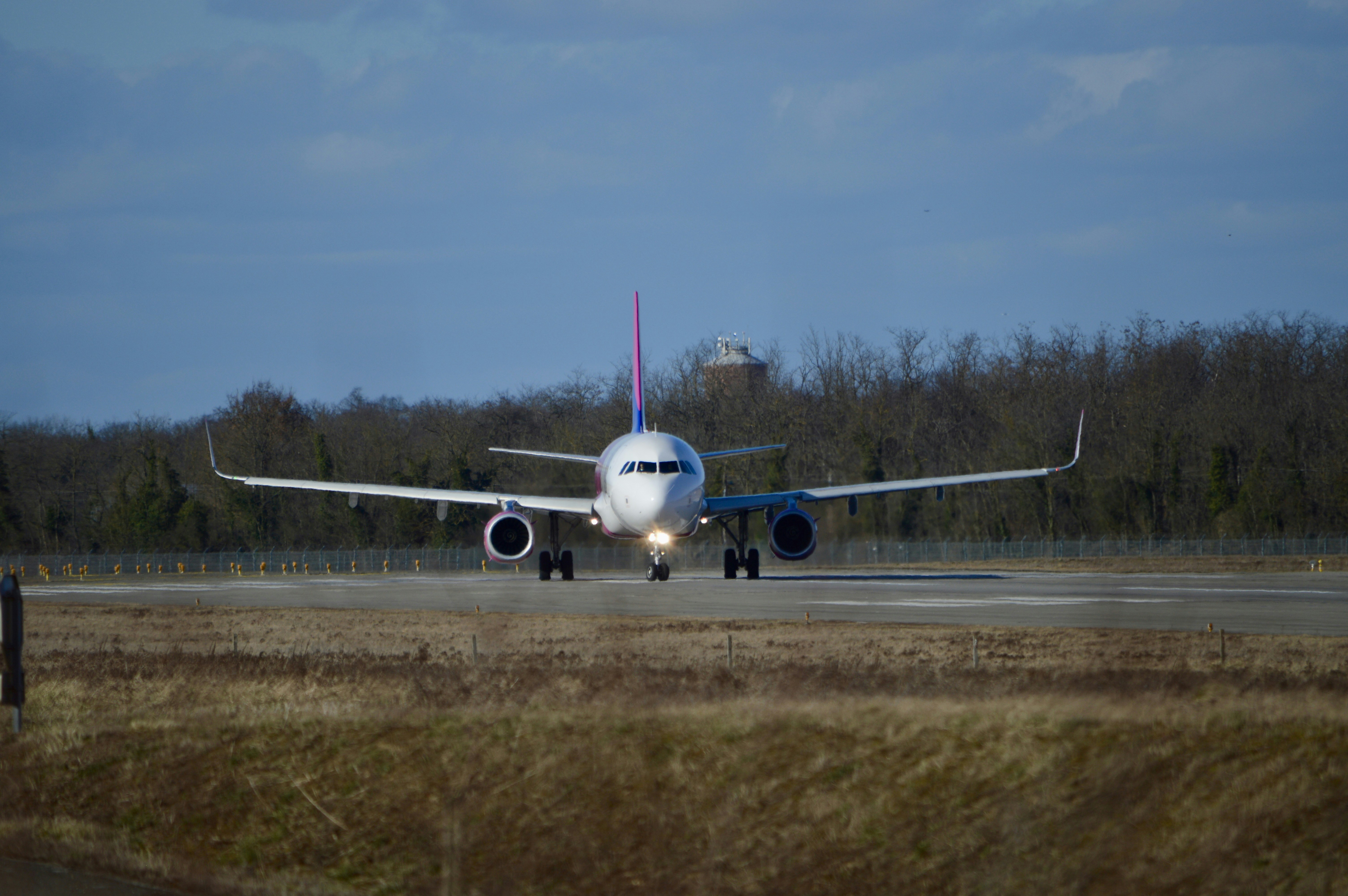 a large jetliner sitting on top of an airport runway, 