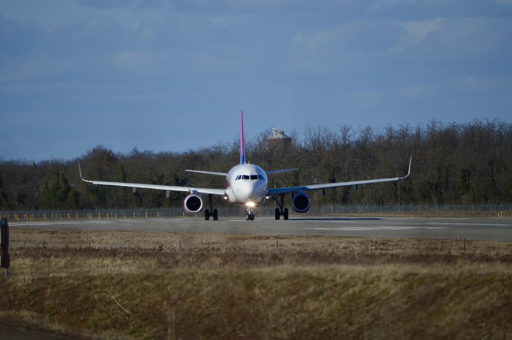 a large jetliner sitting on top of an airport runway