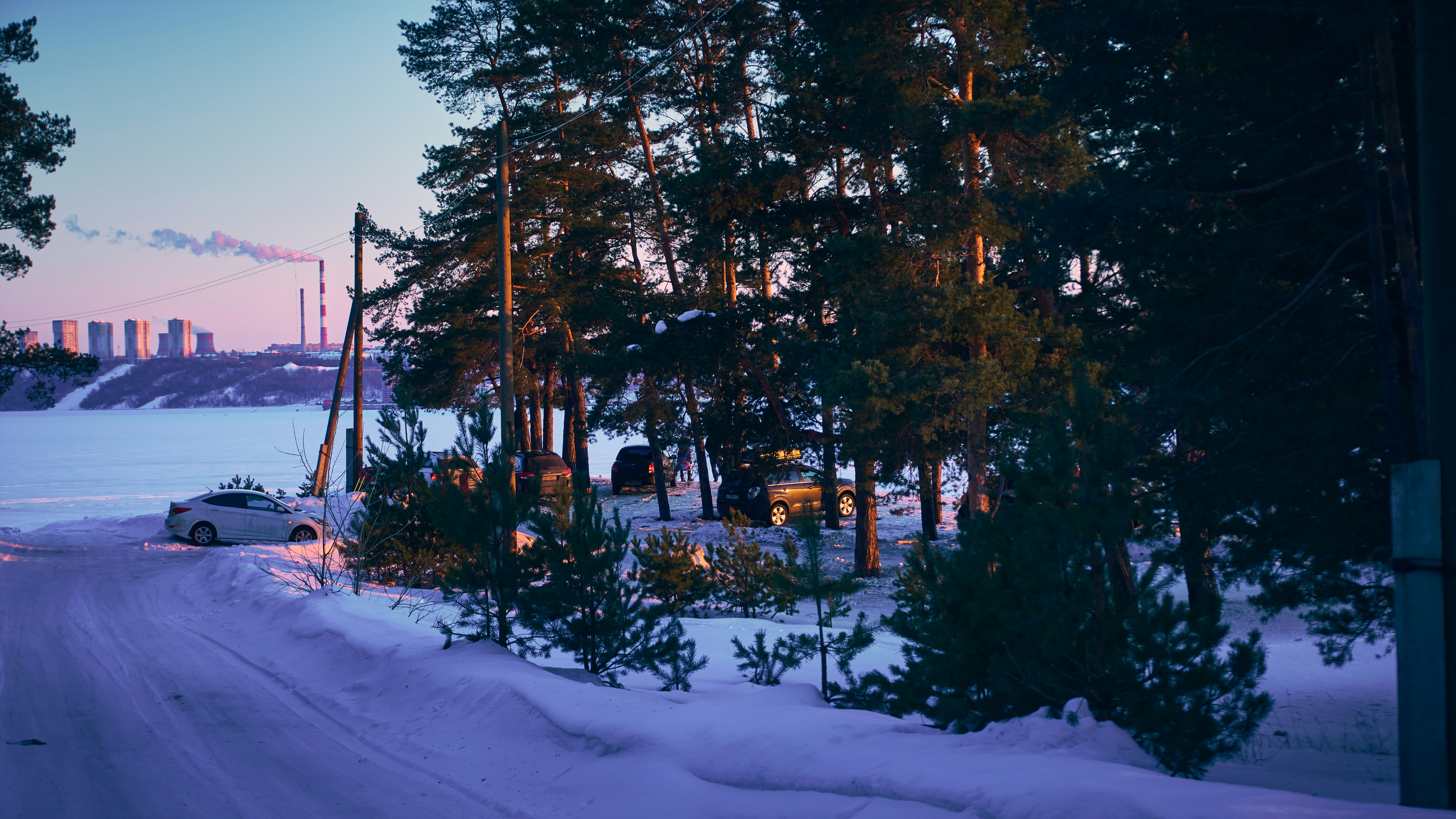 a car driving down a snow covered road