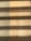 Wooden flooring with alternating vertical slats on the left side. Shadows cast across the surface, creating a pattern of light and dark bands.