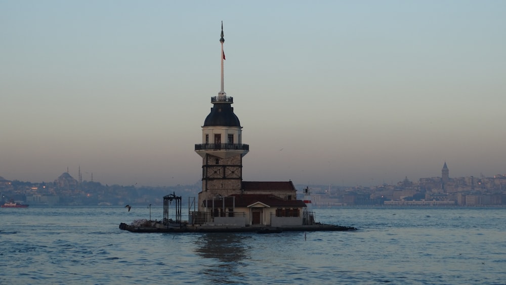 a lighthouse on a small island in the middle of a body of water